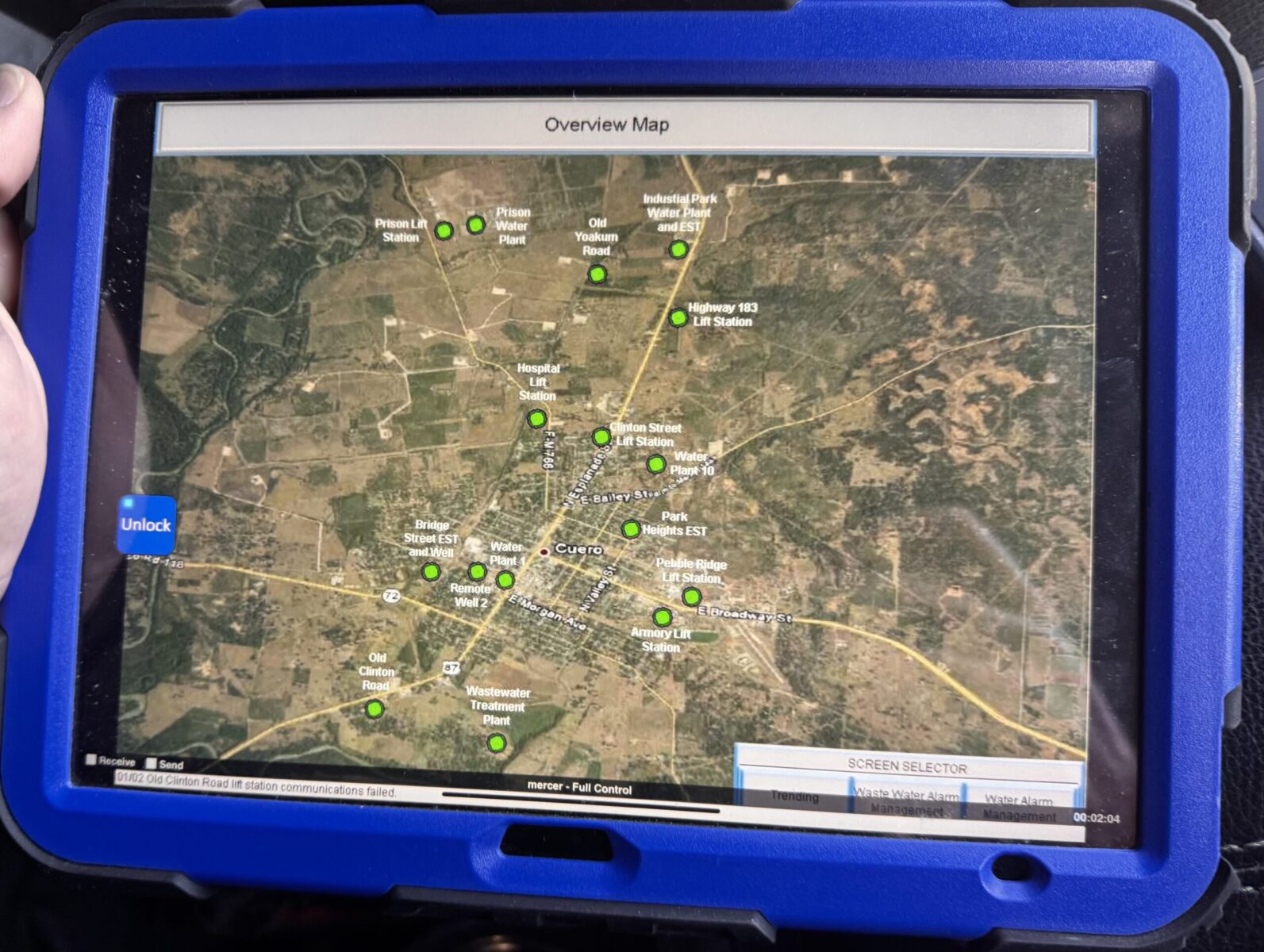 Tablet showing an overview map of a utility system with green status dots at each site