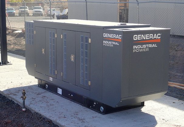 Generac Industrial Power standby generator set on a new concrete pad at a fenced water site