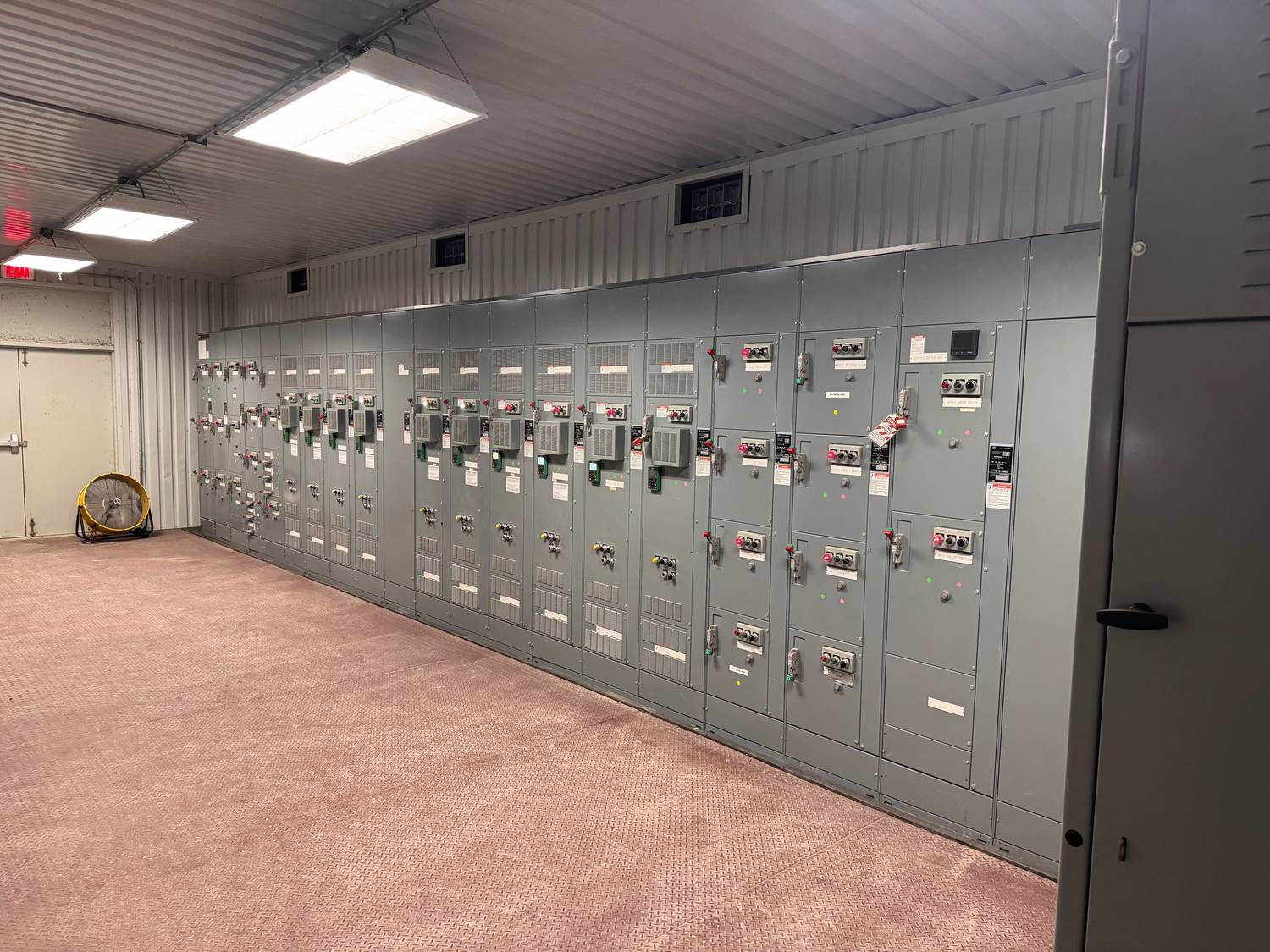 Row of motor control centers built by Mercer Controls installed in a plant electrical room