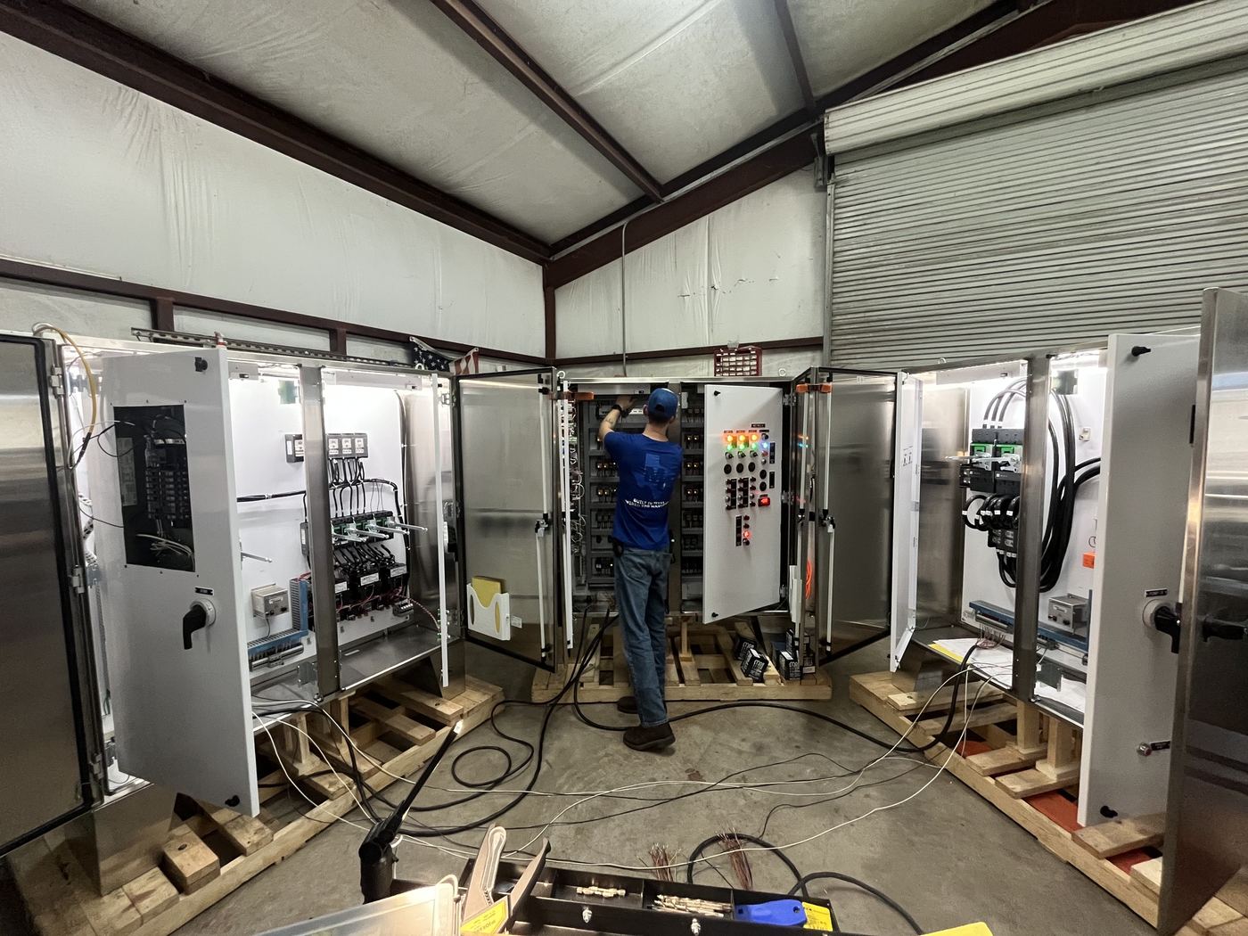 Mercer Controls technician wiring custom UL 508A control panels in the Edna, Texas shop