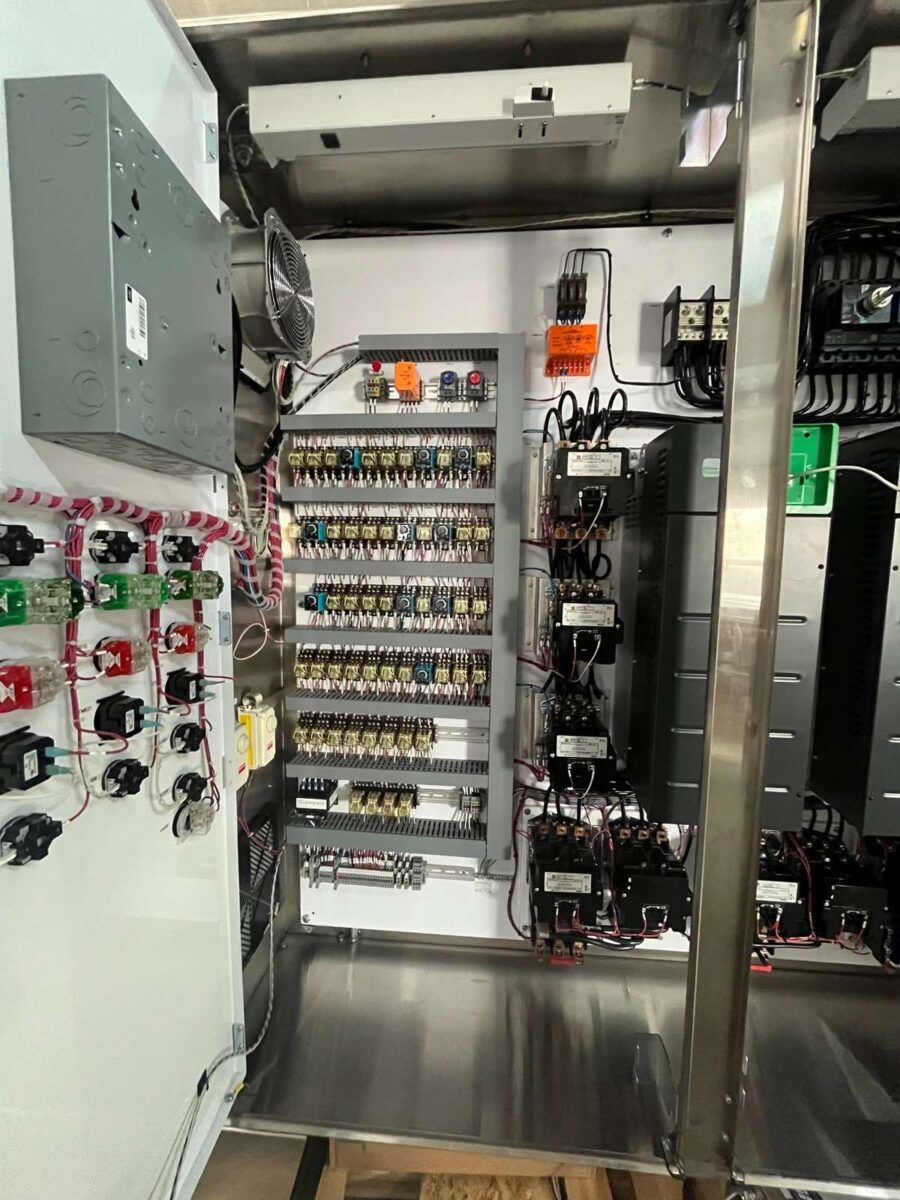 Control panel interior with relays, contactors and labeled terminal blocks