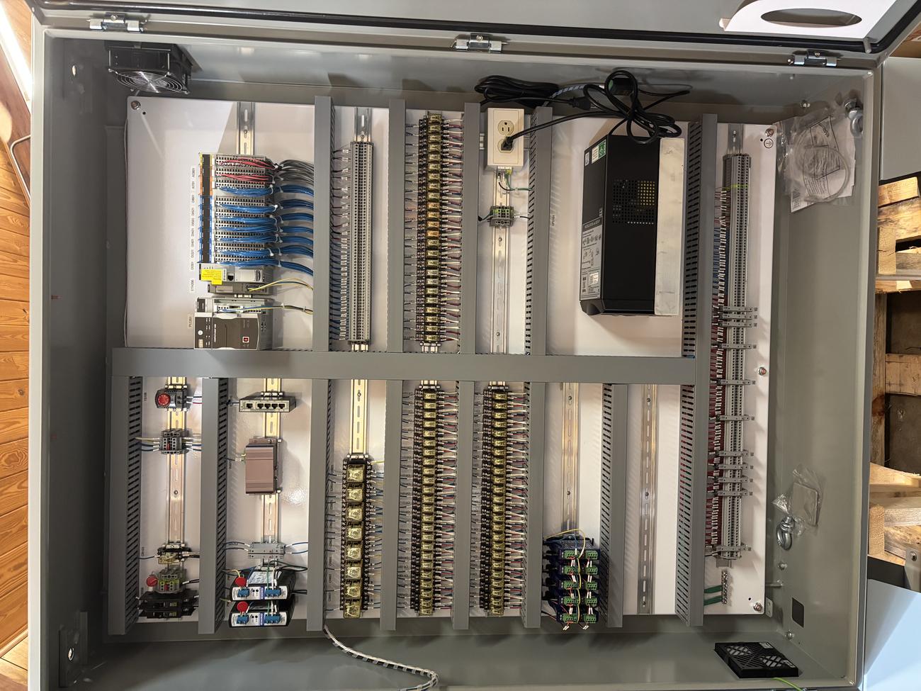 Interior of a Mercer Controls UL 508A panel showing terminal strips and organized wiring